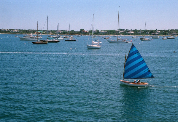a blue sailboat in nantucket harbor
